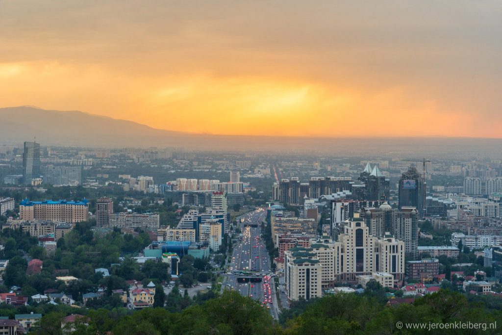 An orange sun lights the evening sky above Almaty